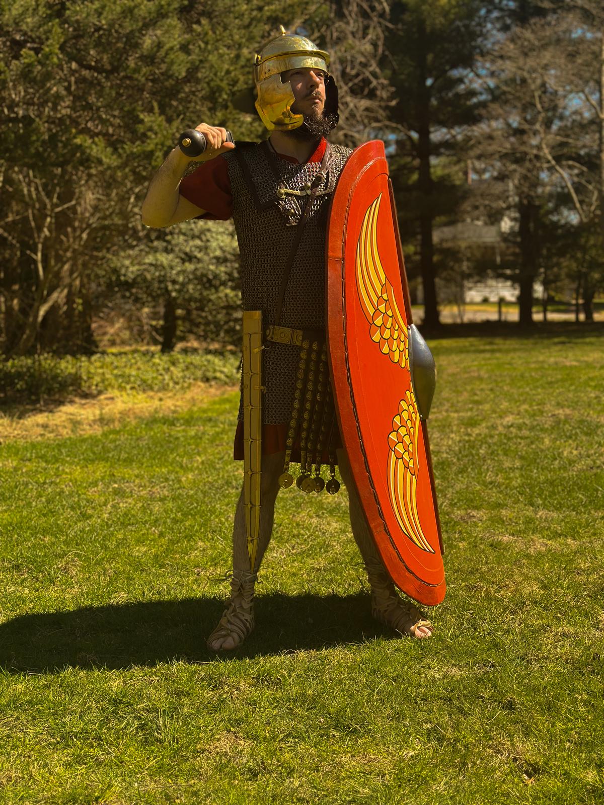 A late Republic Roman legionary holding his shield, sword over his shoulder, staring into the distance